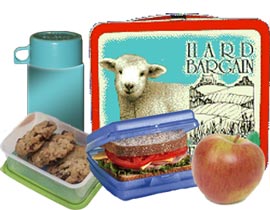 Lunch box with thermos of drink, sandwich and cookies in reusable containers and an apple